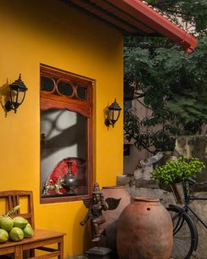Yellow-walled entry courtyard with terracotta pots
