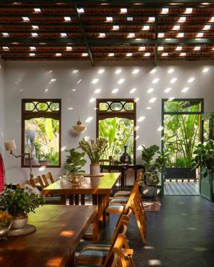 Dining room with a clay-tile ceiling and long timber tables